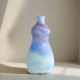 Multicolored ceramic vase on a light gray background