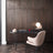 Modern desk with a chair against a wooden wall