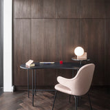 Modern desk with a chair against a wooden wall