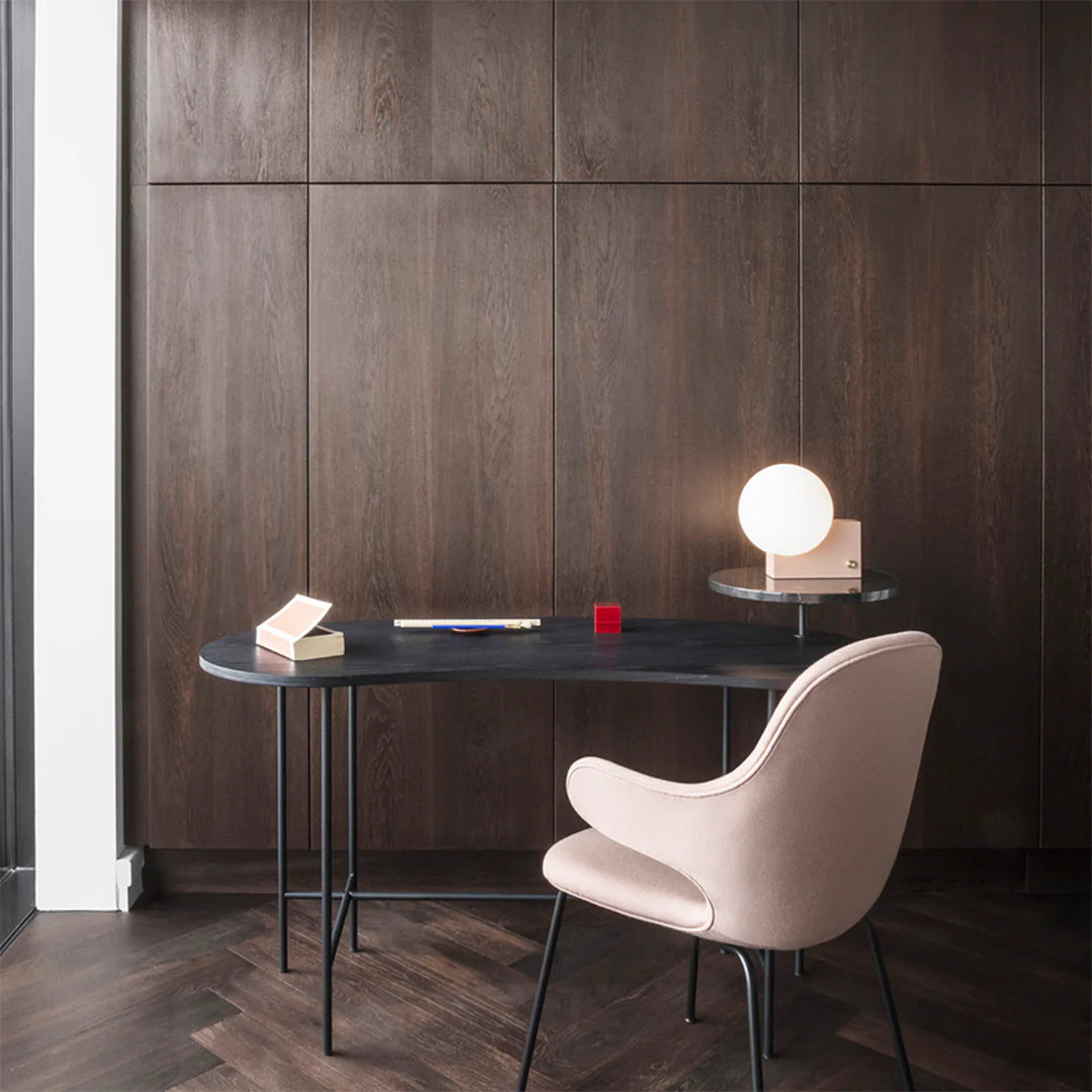 Modern desk with a chair against a wooden wall
