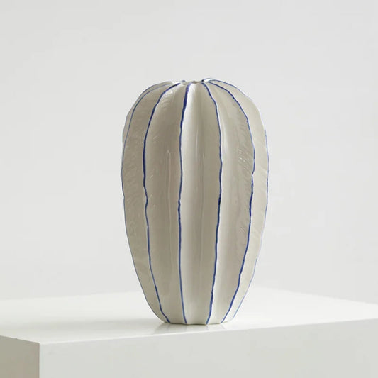 White pillow with blue stripes on a white background