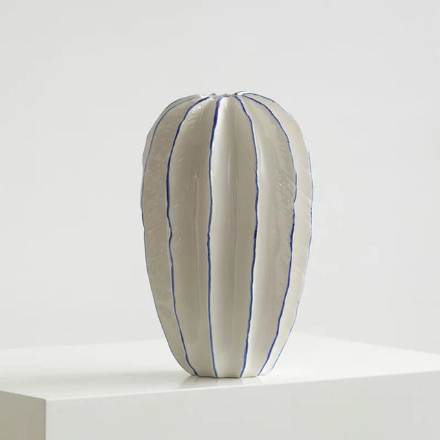 White pillow with blue stripes on a white background