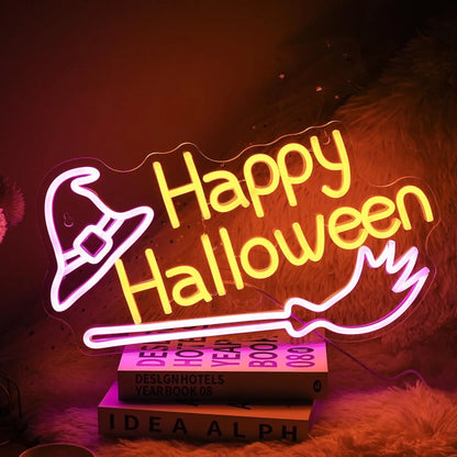Neon sign with 'Happy Halloween' text and witch hat on books against a dark background