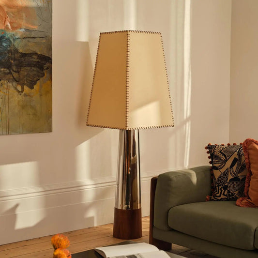 Floor lamp with a beige shade in a living room setting