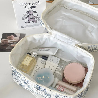 Cosmetic bag with skincare products on a table with a magazine in the background