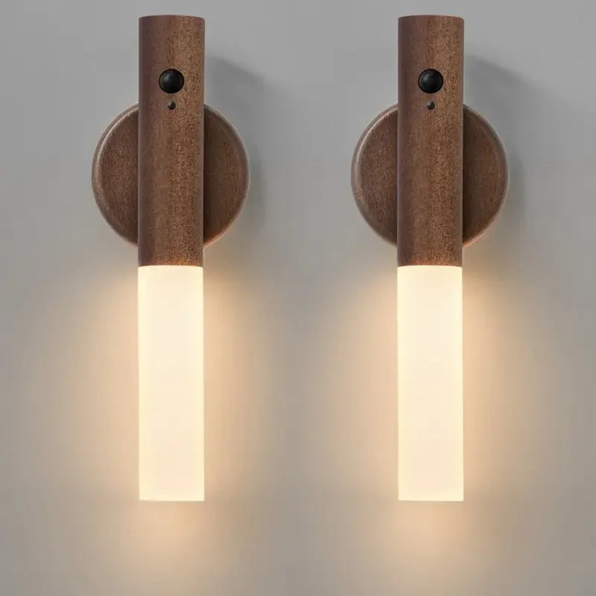Two wooden wall sconces with cylindrical design on a gray background