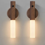Two wooden wall sconces with cylindrical design on a gray background