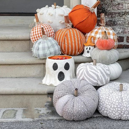 Decorative pumpkins with various patterns on a stone step.