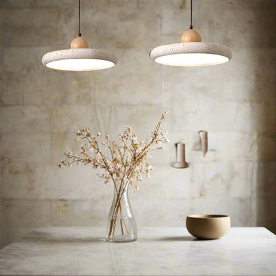 Dining room with pendant lights, table, chairs, and decorative items.