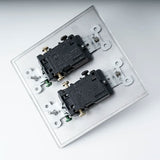 Two black electrical switches on a white background