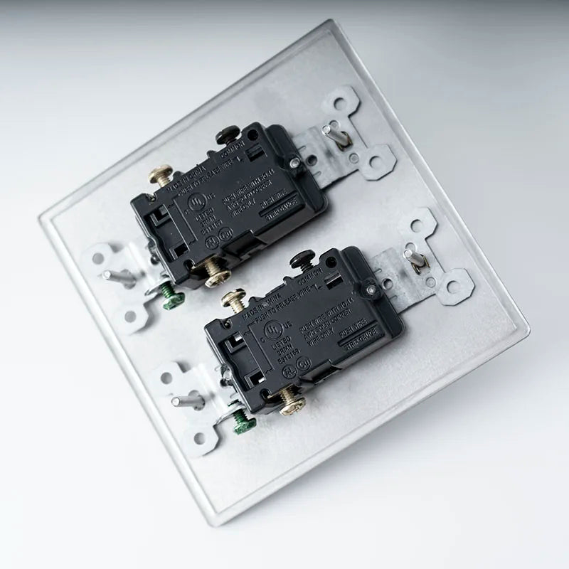Two black electrical switches on a white background