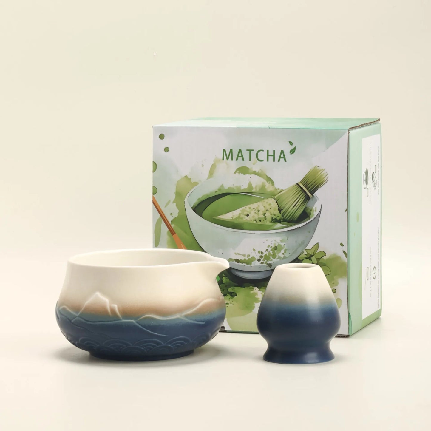 Matcha tea set with two ceramic bowls and a box labeled 'Matcha' on a light beige background.