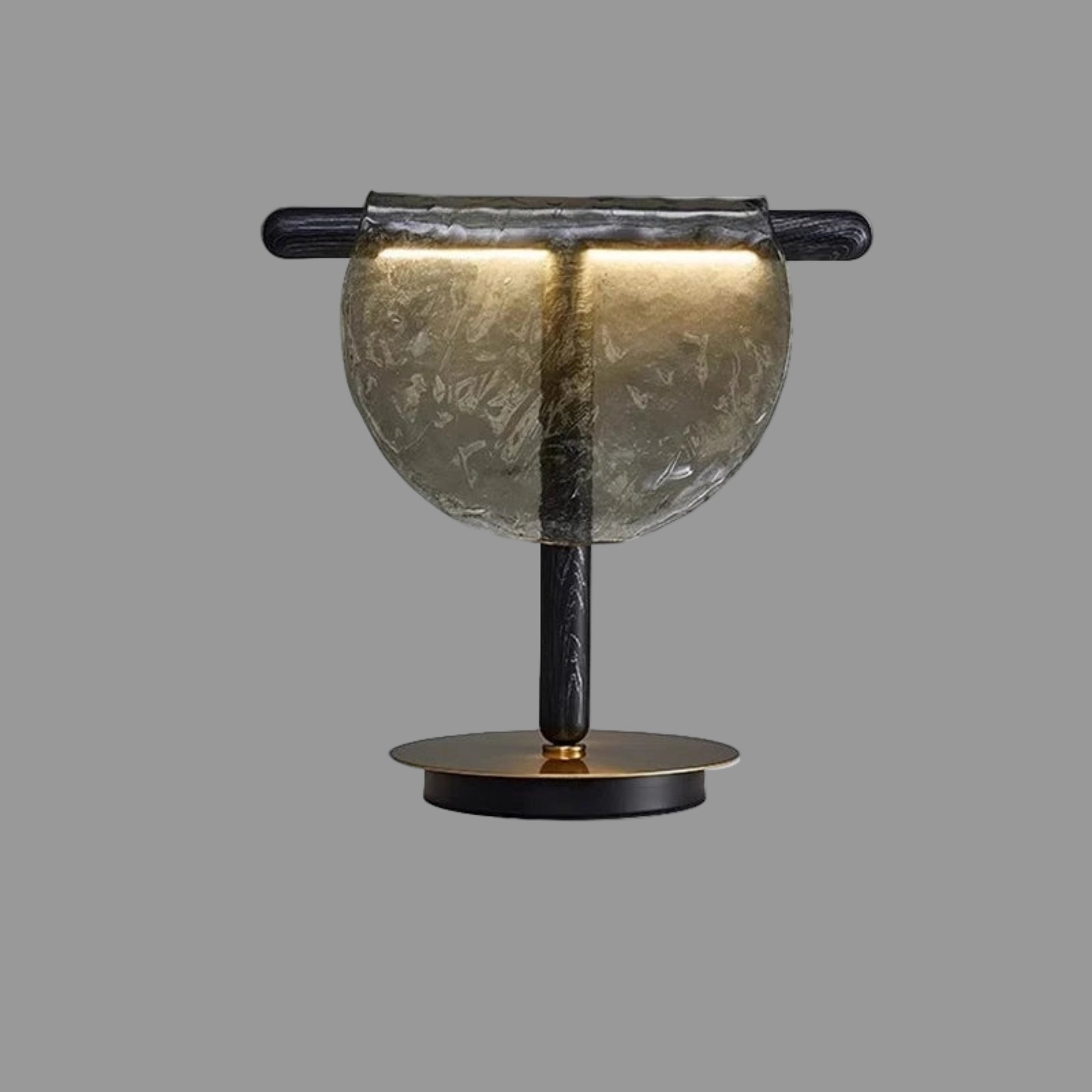 Decorative lamp with marble-like shade and black base on a white background