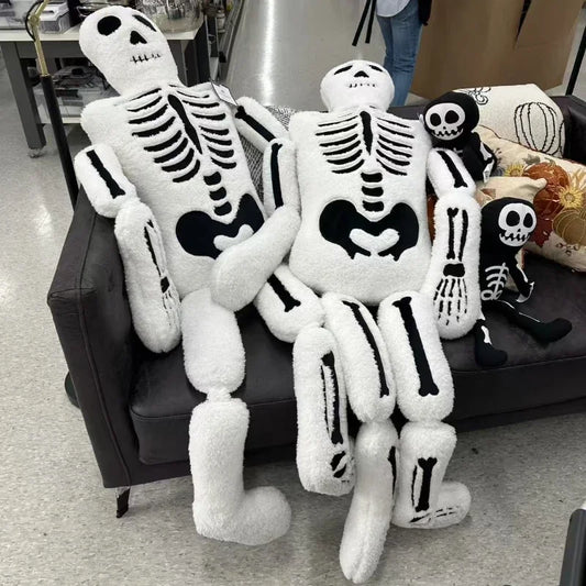 Plush skeleton toys on a couch in a store setting
