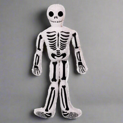 Plush skeleton toy on a white background