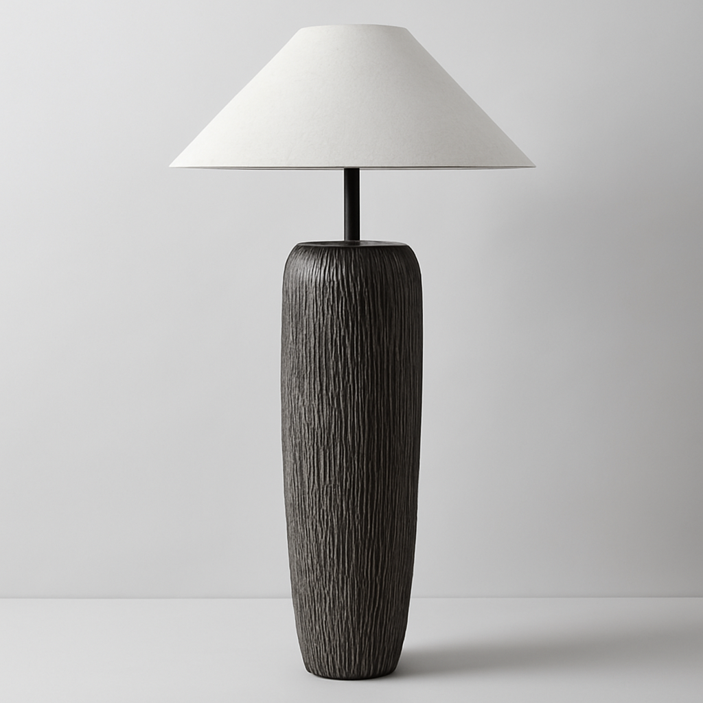 Tall table lamp with textured black base and white shade on a light gray background