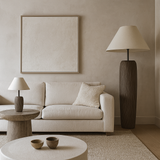 Modern living room with beige sofa, round coffee table, and decorative lamps.