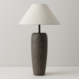 Table lamp with wooden base and white shade on a plain background