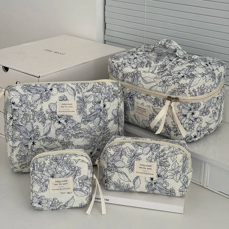 Set of floral-patterned travel bags on a light surface