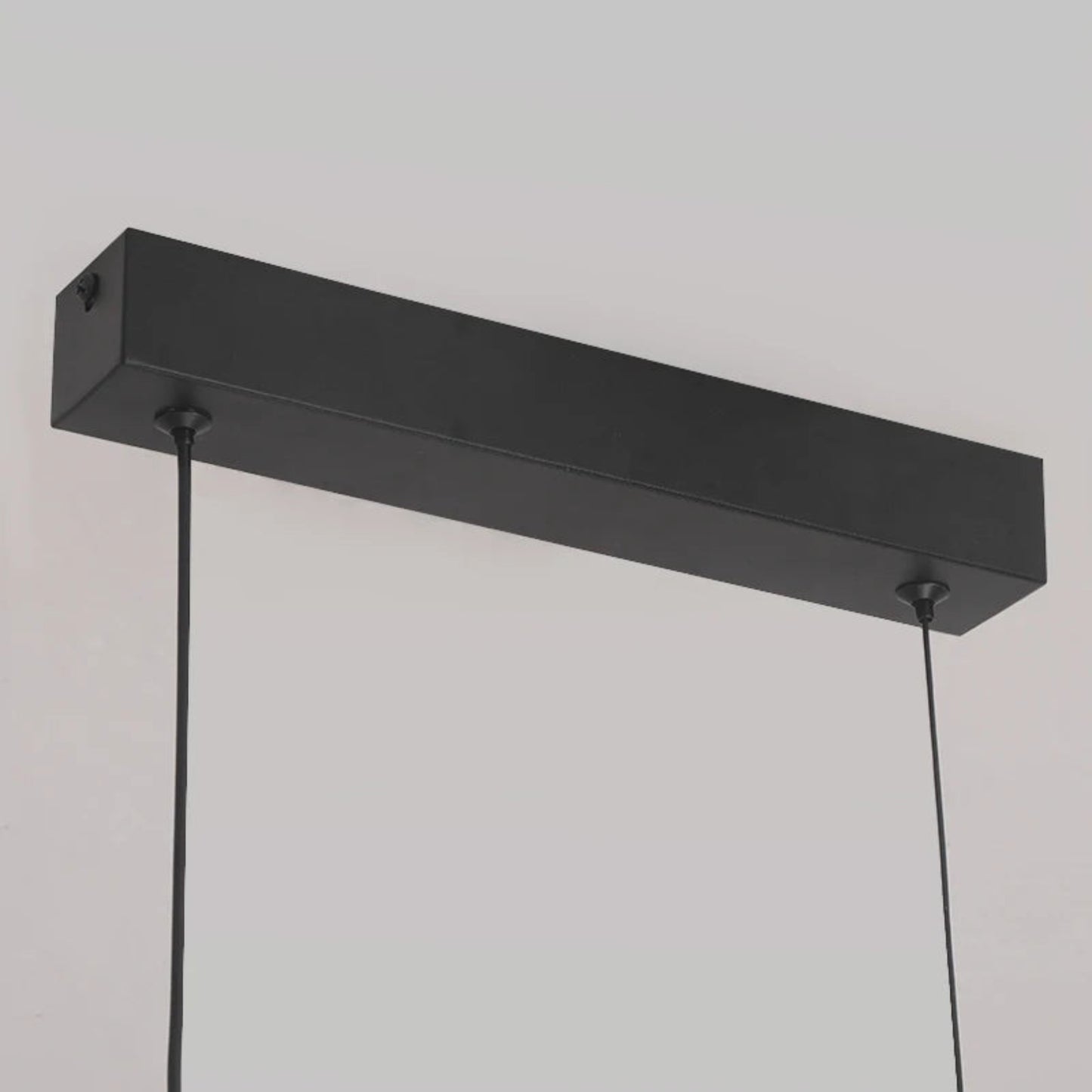 Black rectangular pendant light fixture on a neutral background