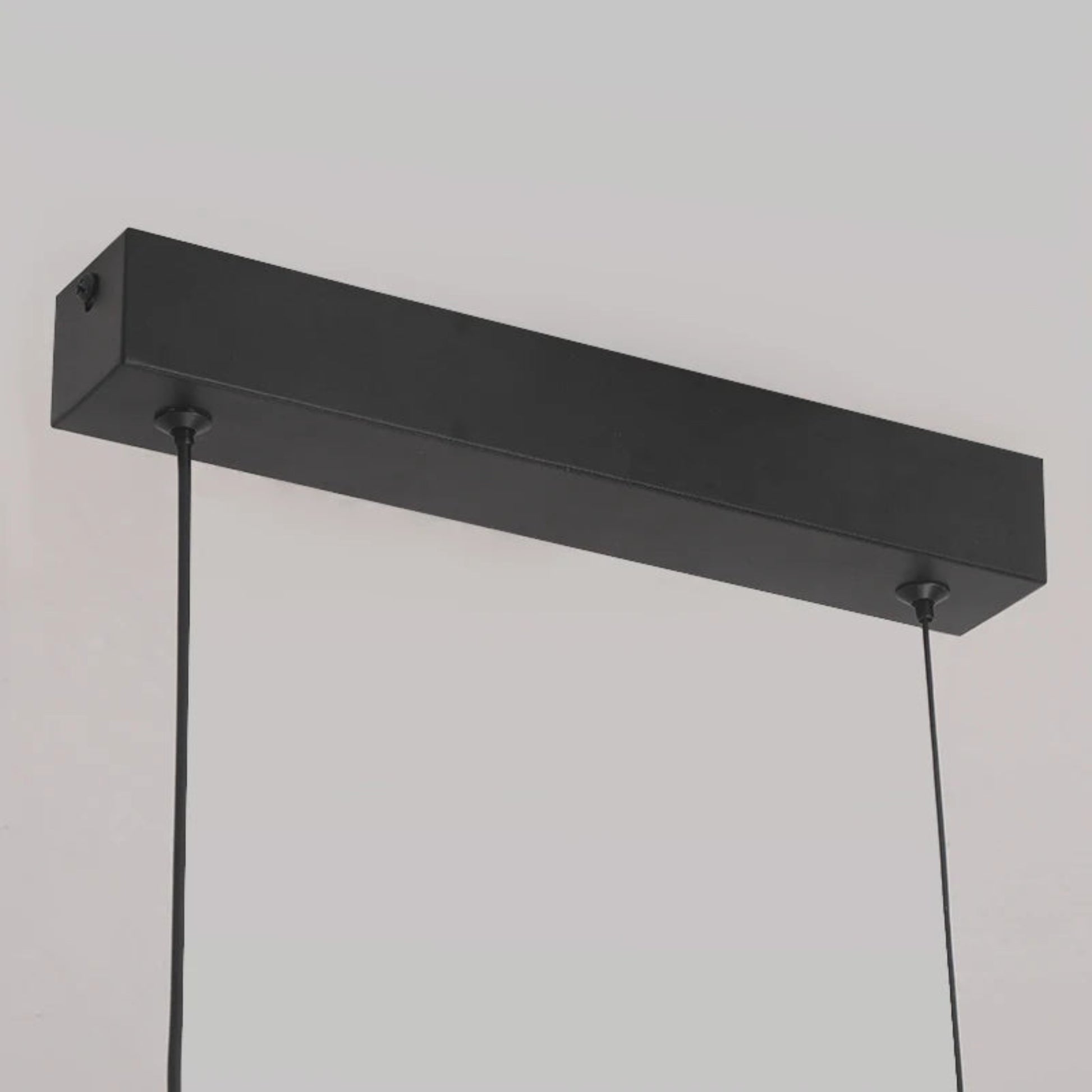 Black rectangular pendant light fixture on a neutral background