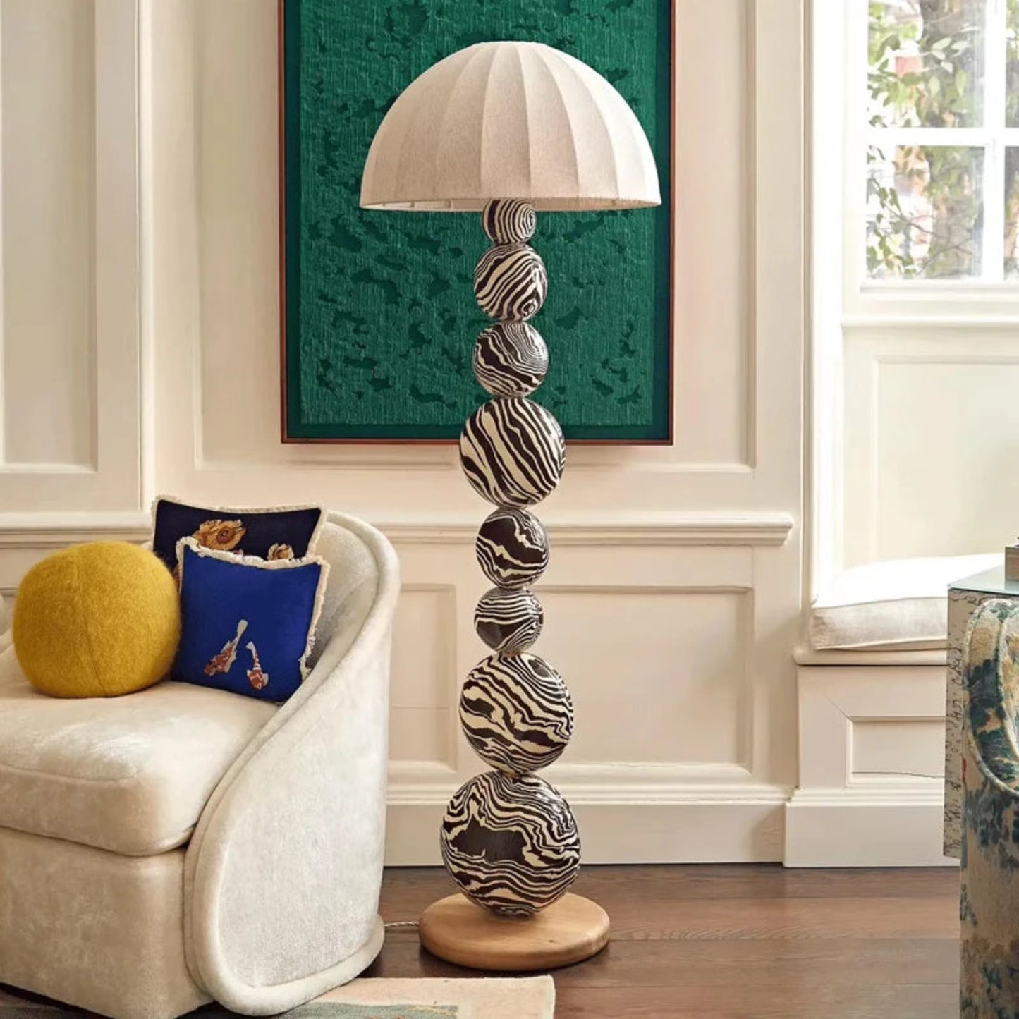 Decorative floor lamp with patterned design in a living room setting.