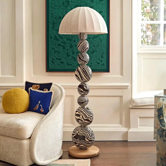 Decorative floor lamp with patterned design in a living room setting.