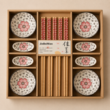 Set of ceramic bowls and chopsticks with floral design in a wooden box