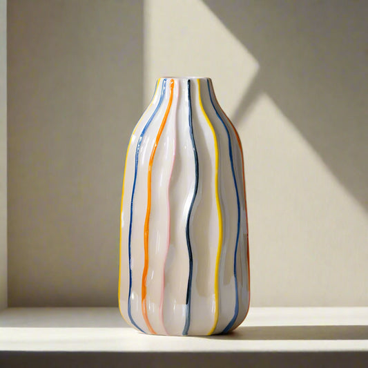 Decorative vase with colorful stripes and measurements on a brown background