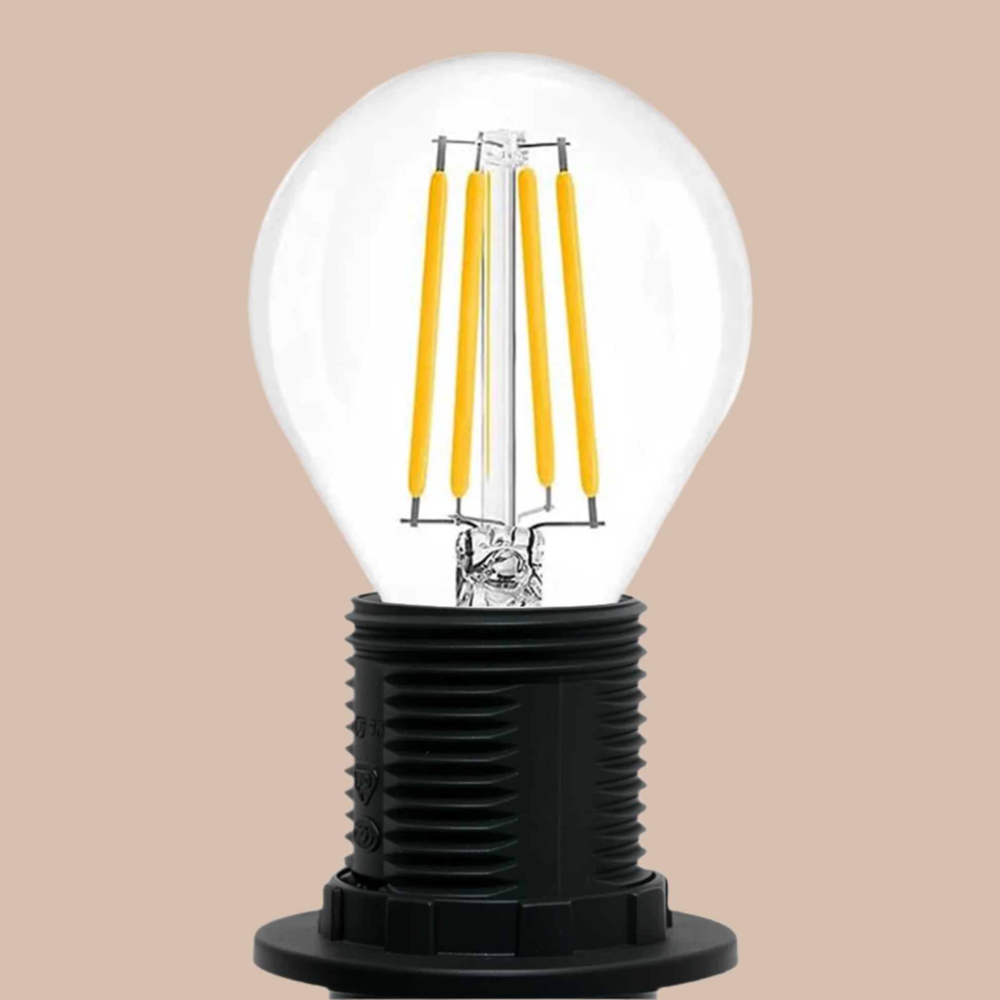 Clear light bulb with yellow filaments inside a black base on a white background