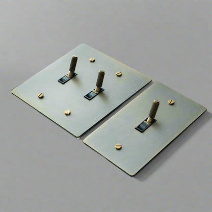 Two metallic square plates with cylindrical protrusions on a gray background, 
