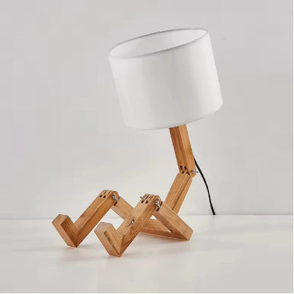 Table lamp with wooden base and white shade on a light gray background