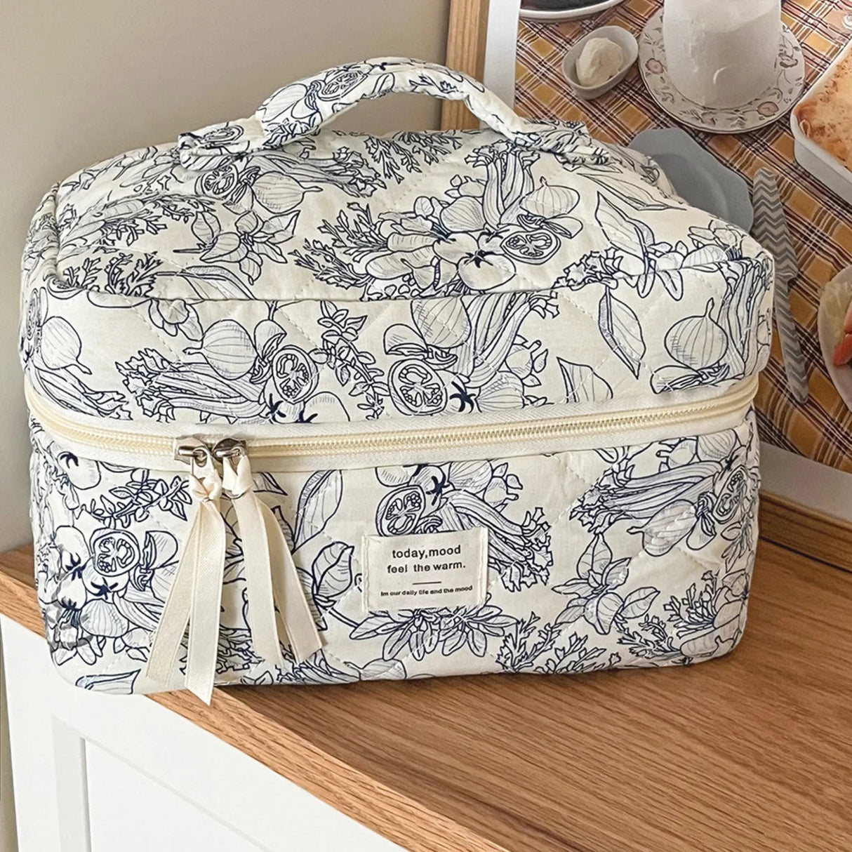 Floral patterned bag on a wooden surface with a blurred background