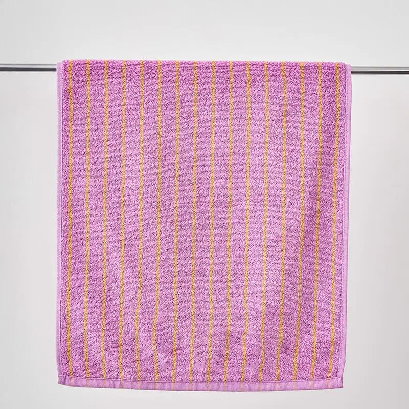 Purple towel with gold stripes on a white background