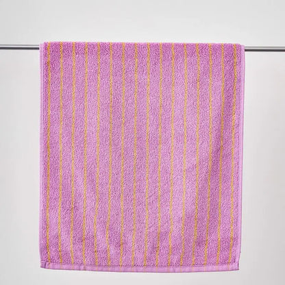 Purple towel with gold stripes on a white background
