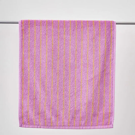 Purple towel with gold stripes on a white background