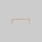 Silver bar earring with small beads on a light gray background