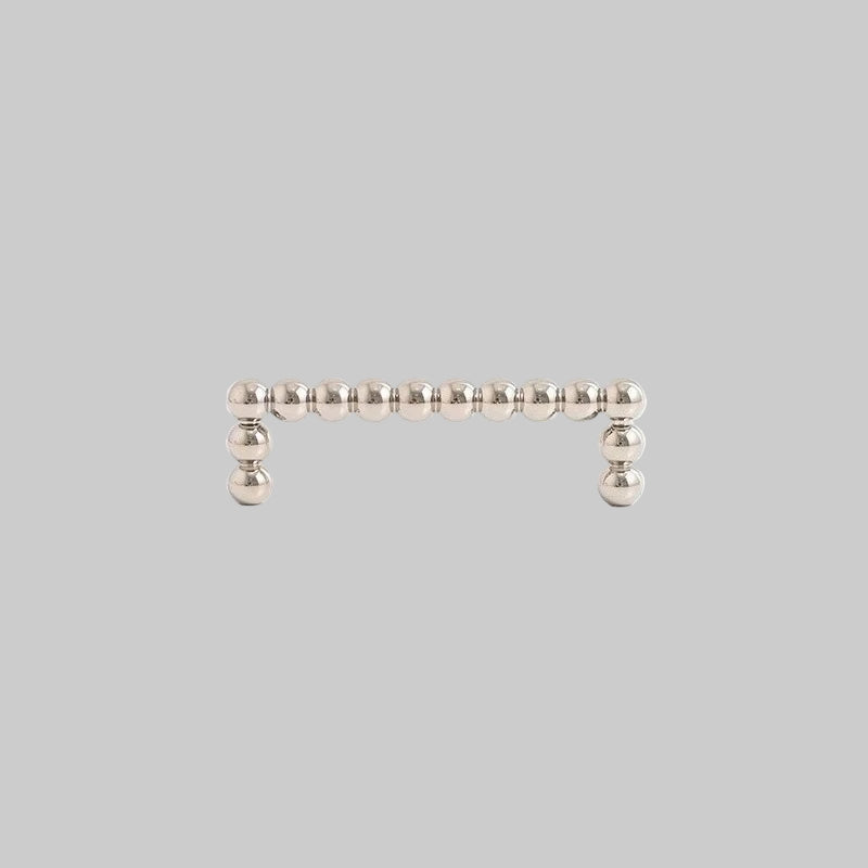 Silver bar earring with small beads on a light gray background