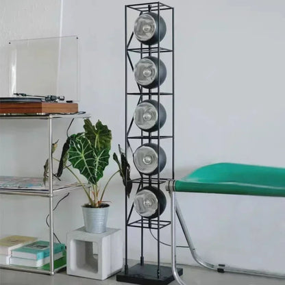 Room interior with a record player, plant, and vinyl record storage rack.