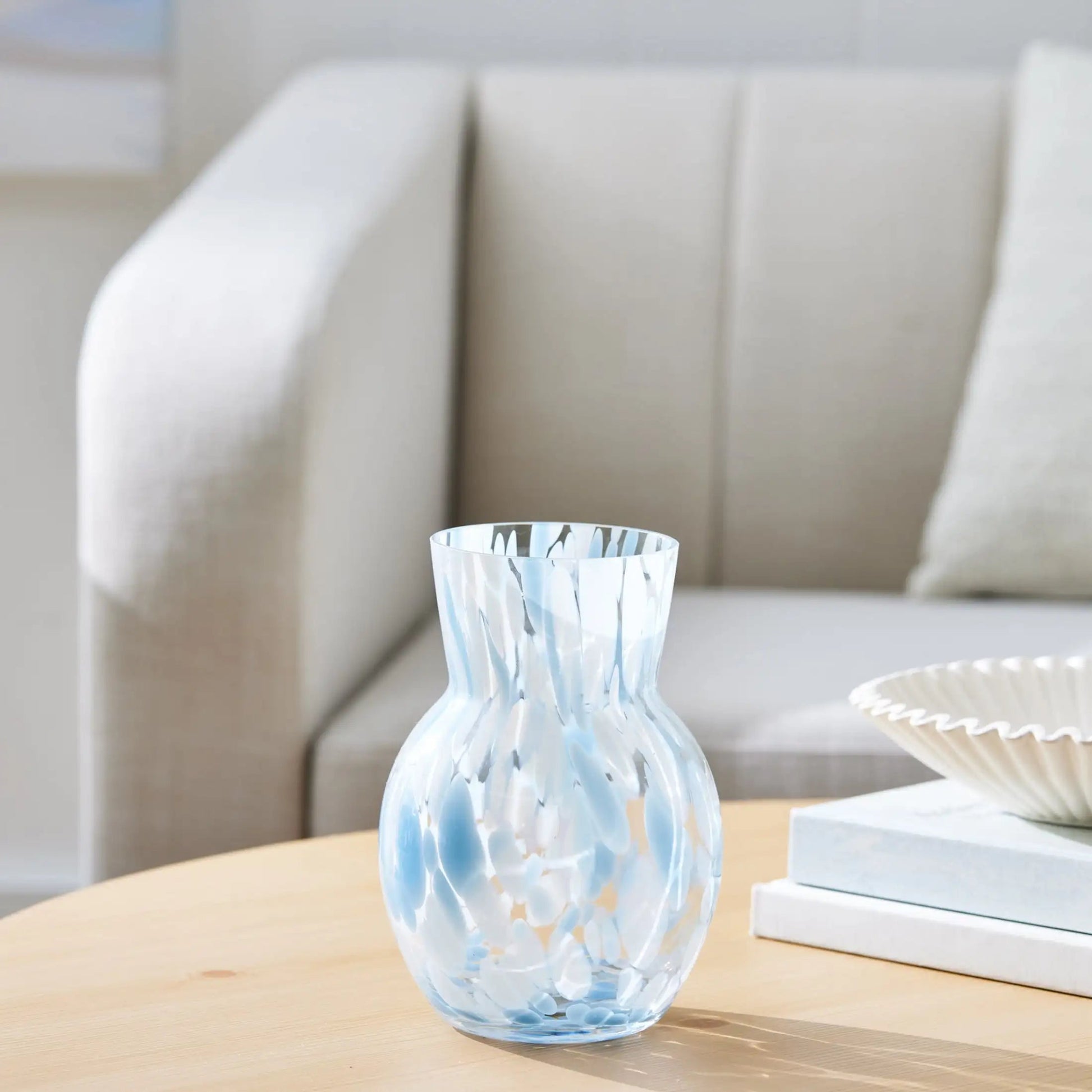 Decorative glass vase on a coffee table with a neutral background