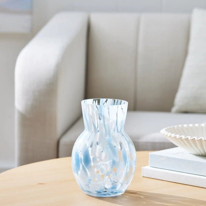 Decorative glass vase on a coffee table with a neutral background