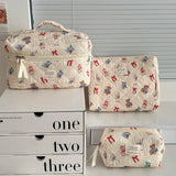 Set of three patterned bags on a white surface with drawers labeled 'one', 'two', and 'three'.