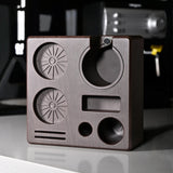 Brass-colored metal block with geometric shapes on a reflective surface