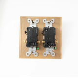 Double electrical switch with brass plate on a white background