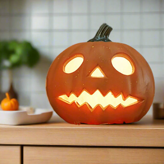 Carved Halloween pumpkin with glowing interior on a dark background