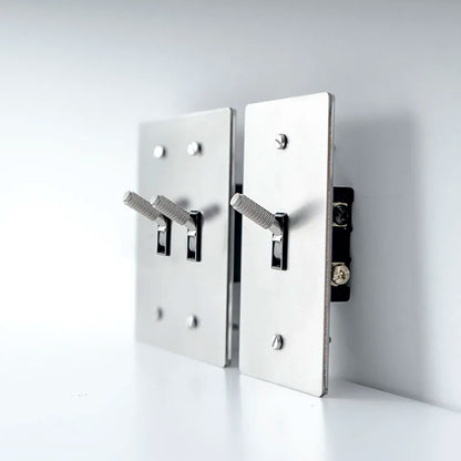 Metallic wall-mounted hooks on a white background