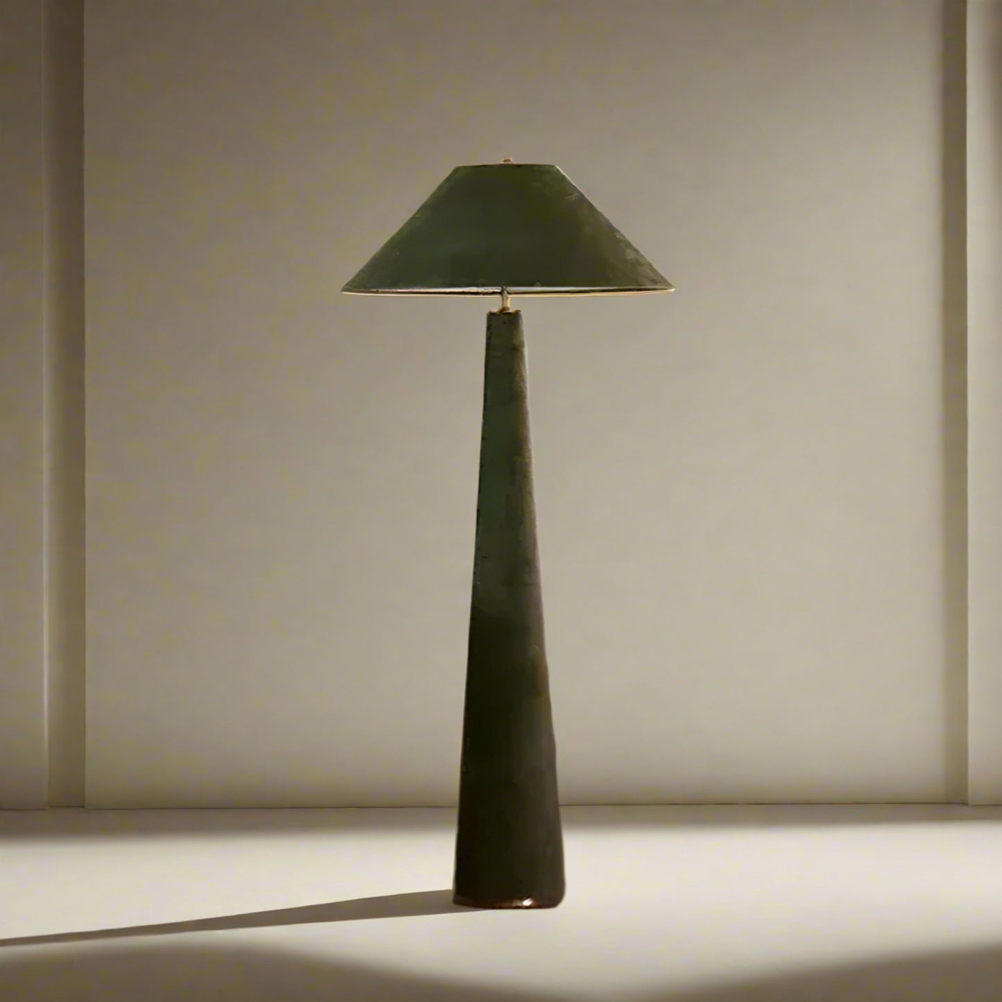 Green floor lamp in a living room setting with a white sofa and wooden chair.

