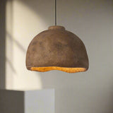 Brown pendant light with a textured surface on a plain background