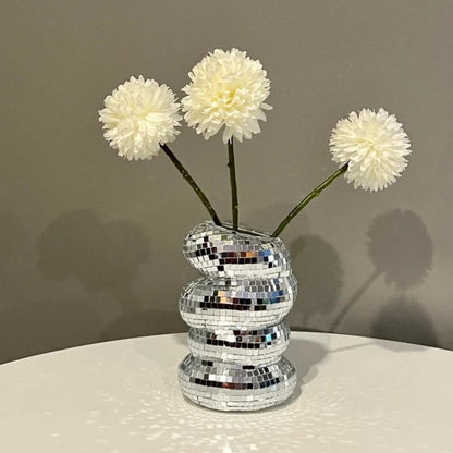 Silver mosaic vase with white flowers on a neutral background