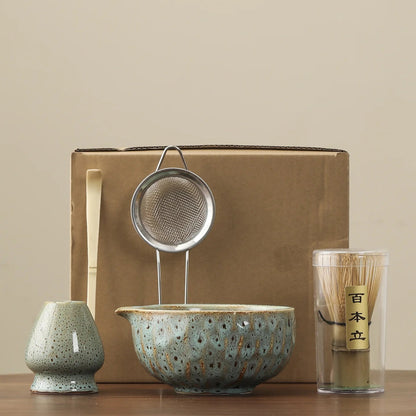 Tea-making set with ceramic bowl, strainer, and glass on a beige background